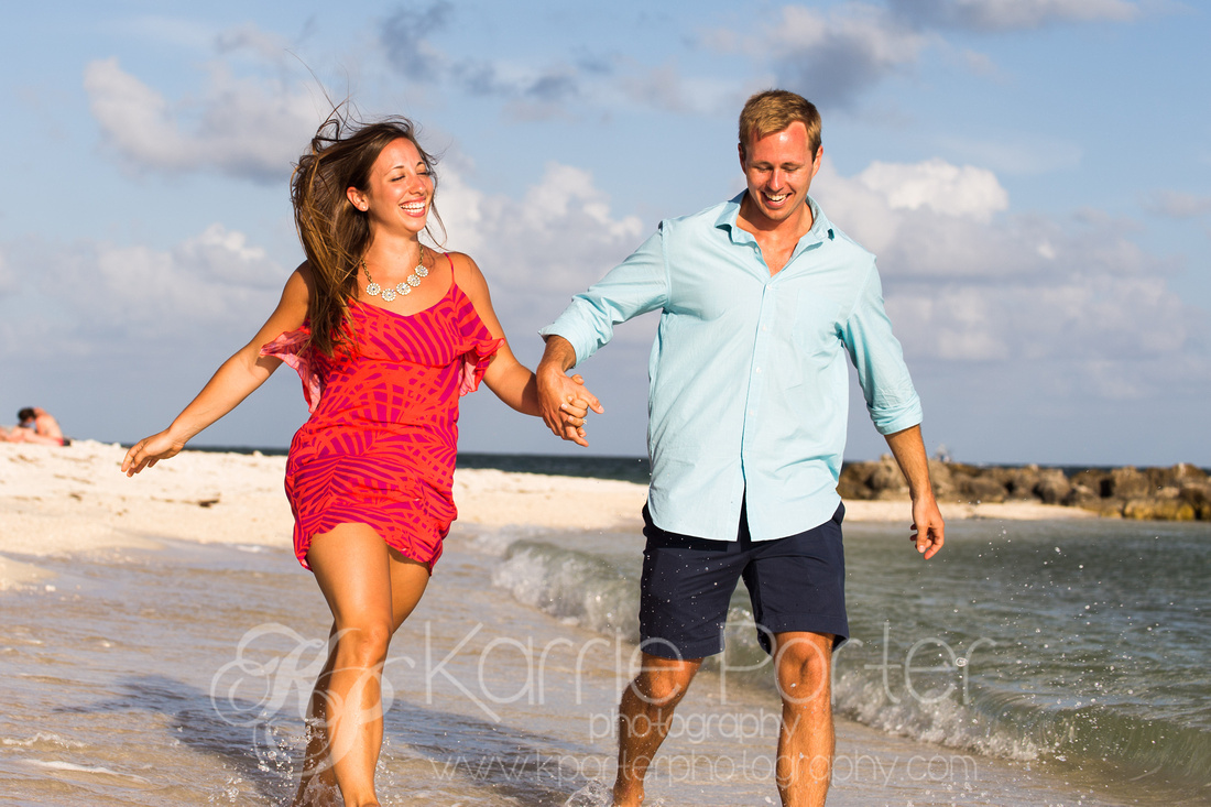 Groom leads his new fiance in a silly frolic down the beach in Key West.  © Karrie Porter Photography