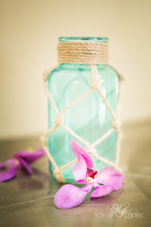 Teal jar and fuschia orchid wedding details