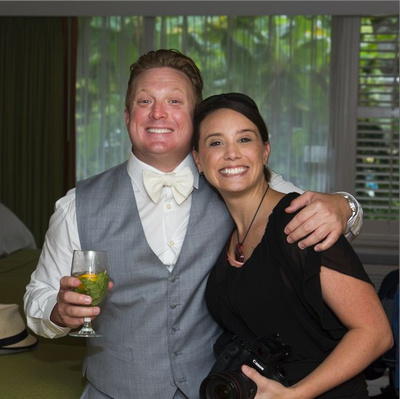Karrie Porter poses with a groom at one of her weddings