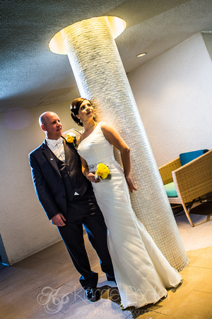 Bride and groom pose by pillar in Hyatt Key West Resort