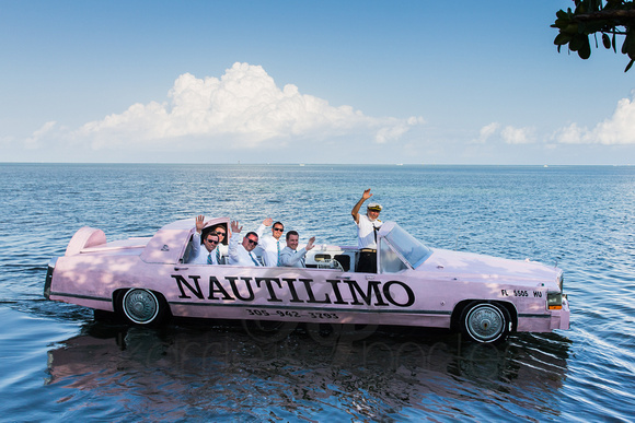 Groomsmen ride in pink floating cadillac Nautilimo.