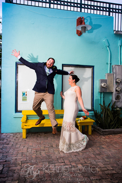 Groom jumps off yellow bench in old town Key West during wedding photo shoot.