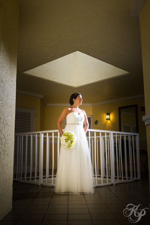 Diamond skylight above bride posing by angular railing.
